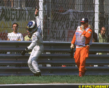 Hakkinen slams his gloves  furiously