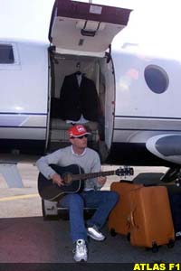 Eddie plays guitar near his jet plane
