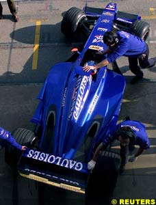 Alesi's Prost is pulled back to the garage